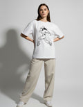 Front view of a white oversized t-shirt for women featuring a black anime-style streetwear girl graphic print.