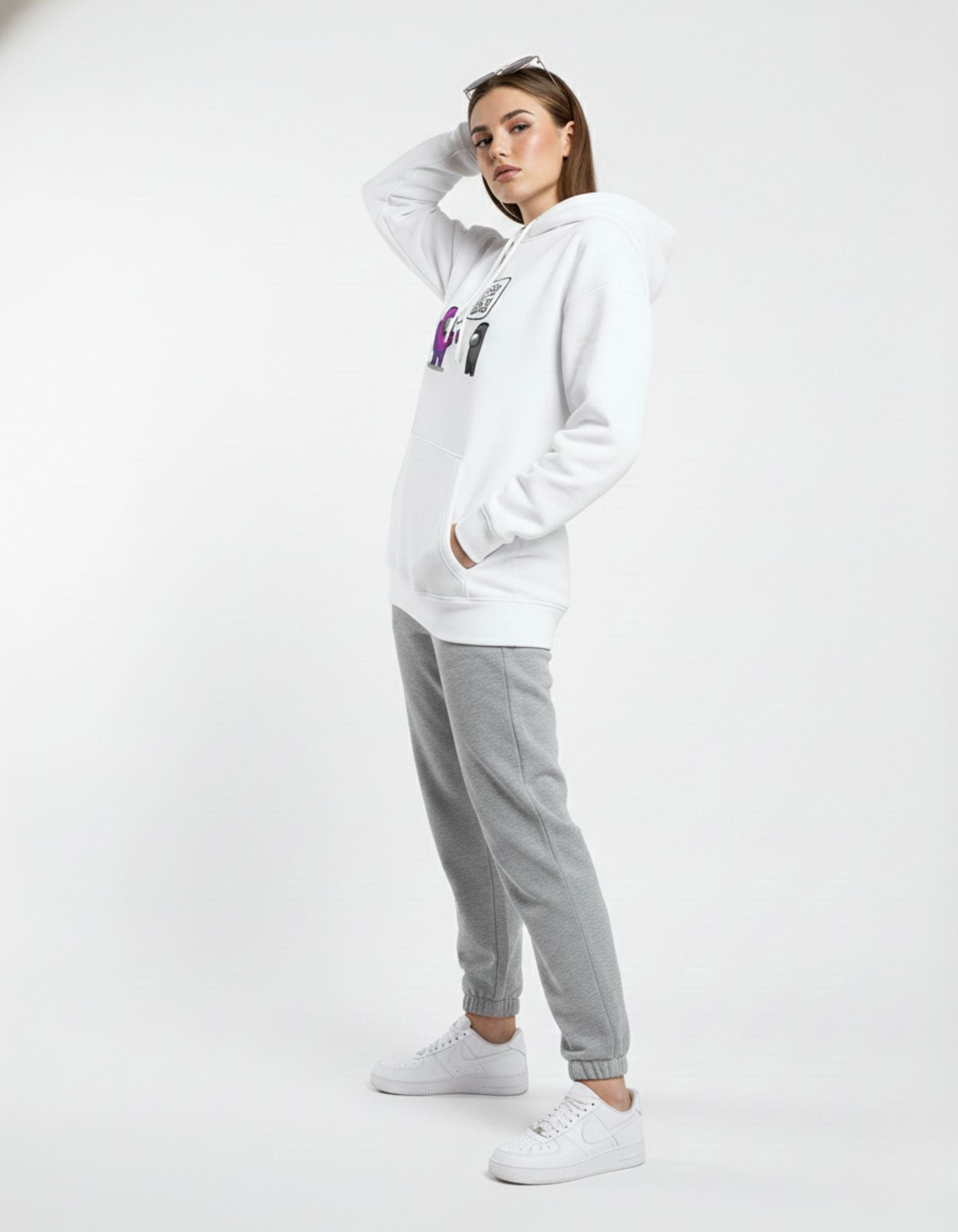 Side profile of a female model wearing an oversized white gaming graphic hoodie, highlighting the sleeve length and relaxed style.