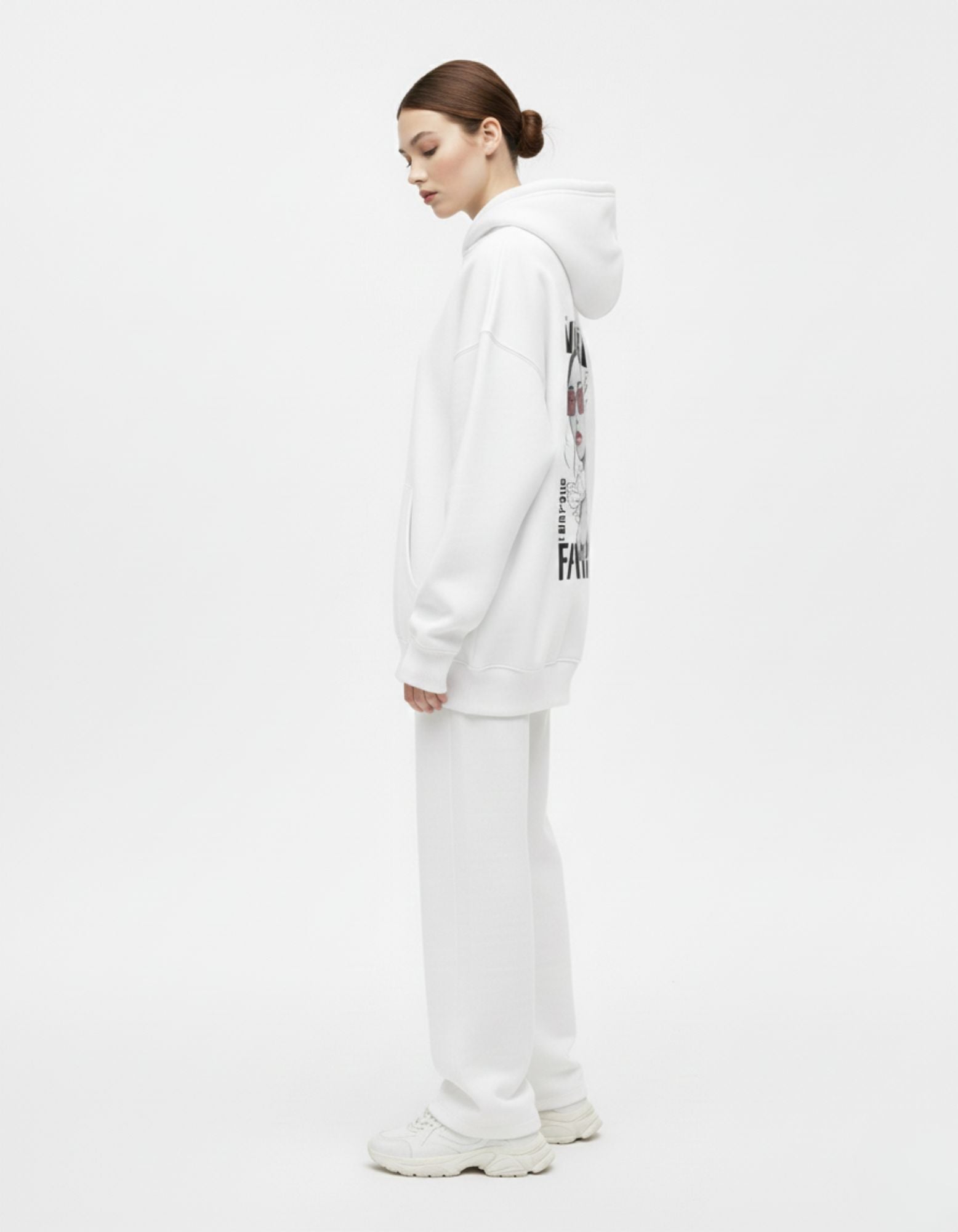 Detailed side profile of a white oversized hoodie with a back graphic, emphasizing the clean, minimalist streetwear aesthetic.