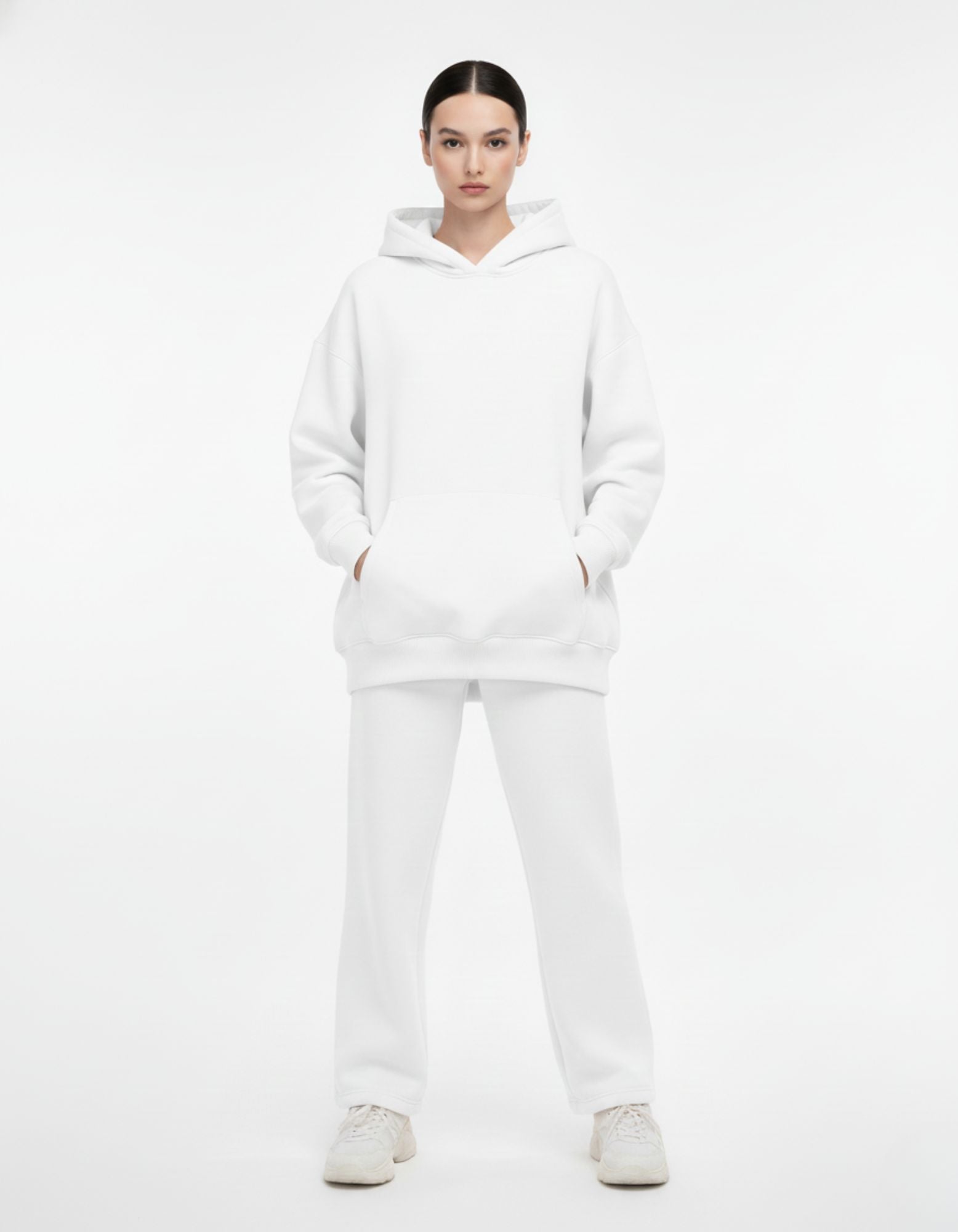 Front view of a premium white oversized hoodie and sweatpants set, featuring a kangaroo pocket and dropped shoulders.