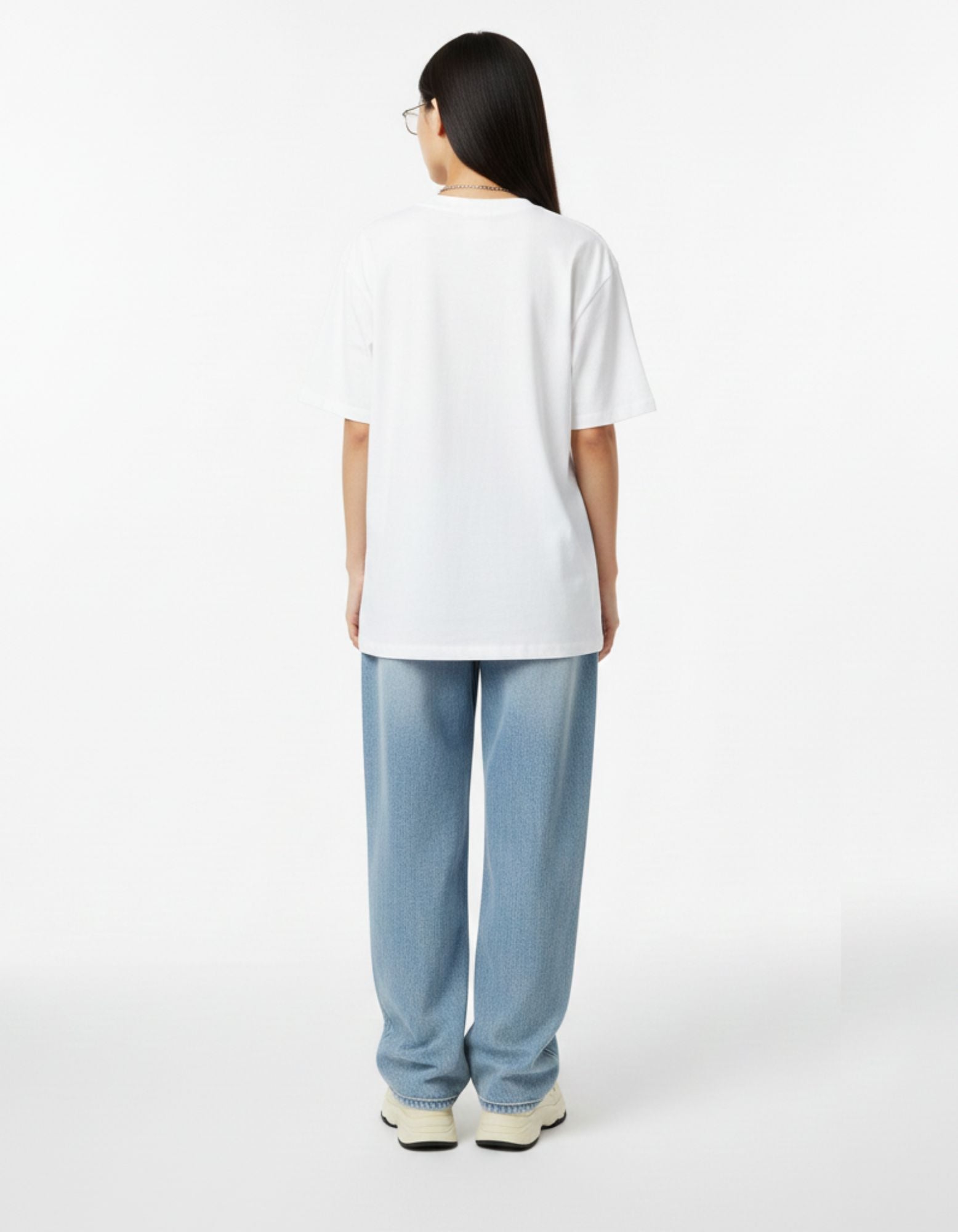 Back view of white oversized meditation graphic t-shirt showing a relaxed boxy fit.