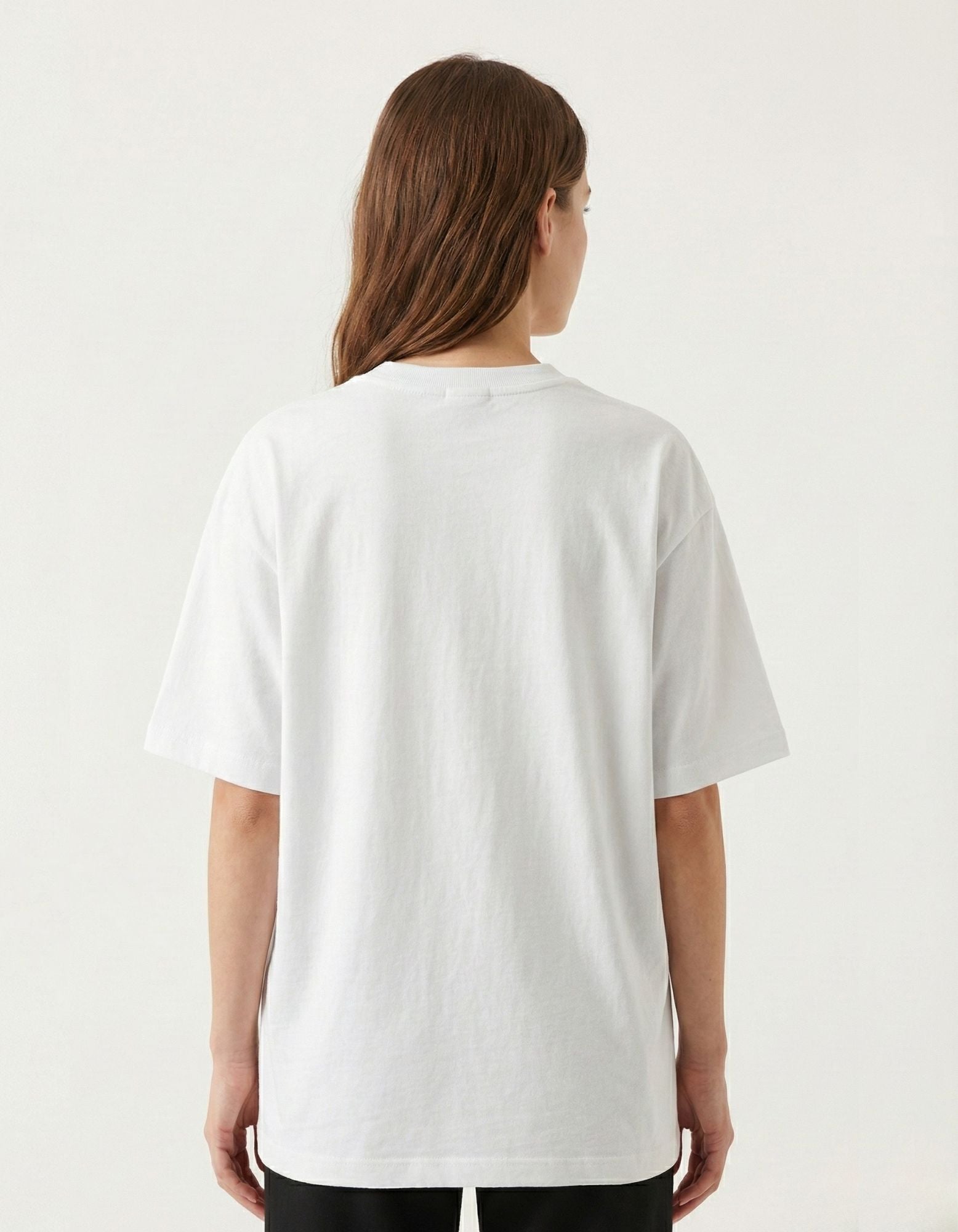 Back view of plain white oversized t-shirt for women, comfortable and relaxed streetwear fit for urban Indian style.