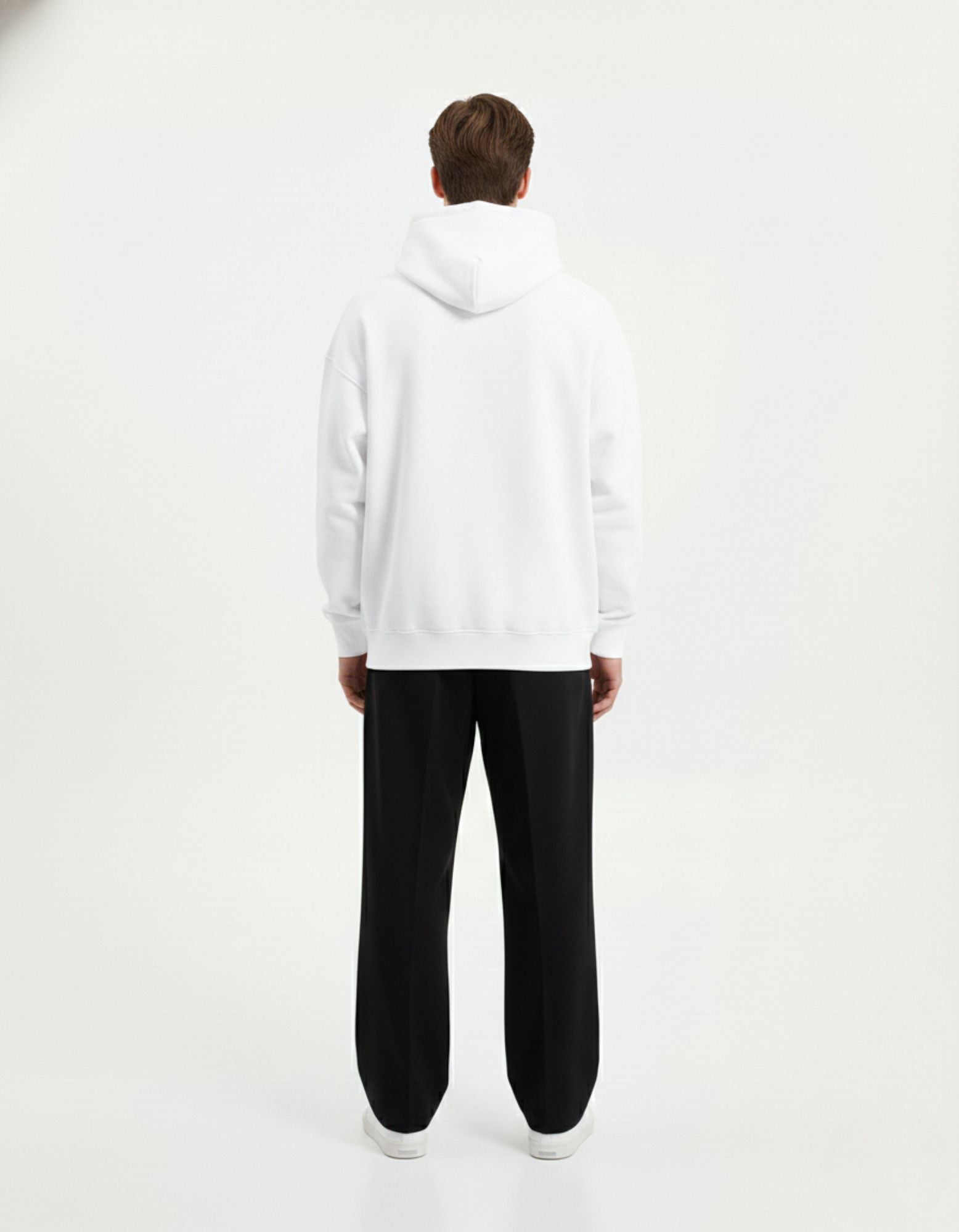 Back view of an oversized white streetwear hoodie for men and women, featuring a clean minimalist design and high-quality fabric.