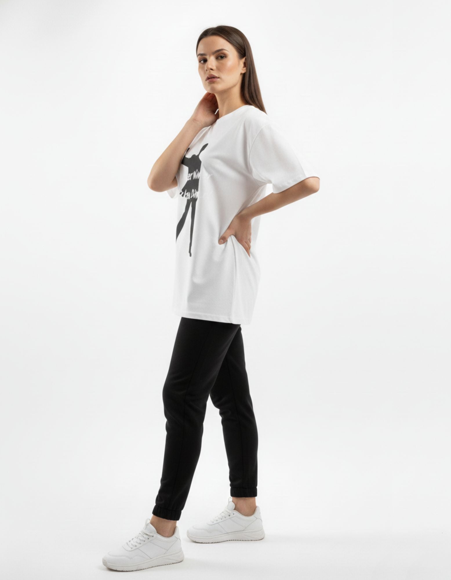 Side profile of a woman in a white graphic gaming tee, highlighting the loose-fit sleeve and premium cotton drape.
