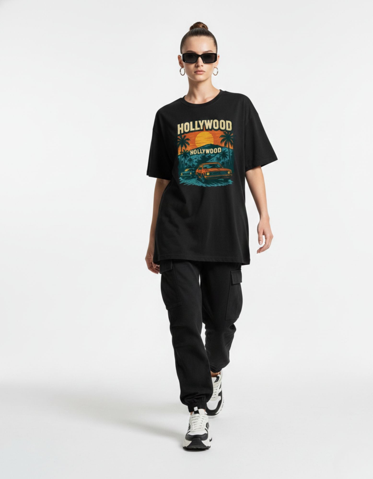Woman styling a black oversized retro graphic t-shirt, vintage aesthetic fashion India.