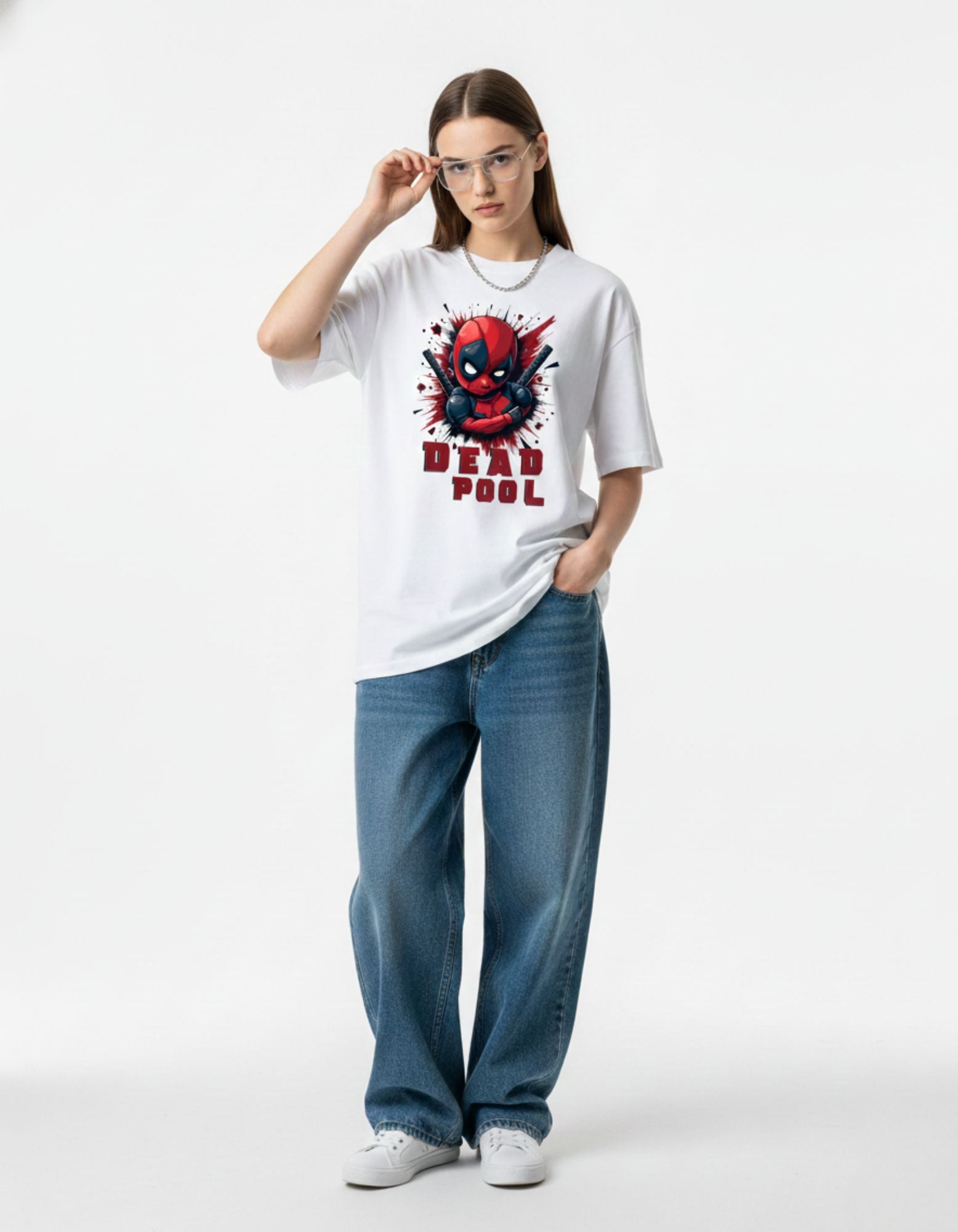 Woman styling white Deadpool oversized t-shirt with baggy jeans, a must-have graphic tee for Indian Gen Z fashion.