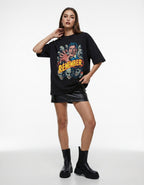 Indian female model in a GENZs Fashion black oversized graphic t-shirt with a vintage horror zombie design and "R.E.M.E.M.B.E.R" text, styled with a leather skirt and boots.