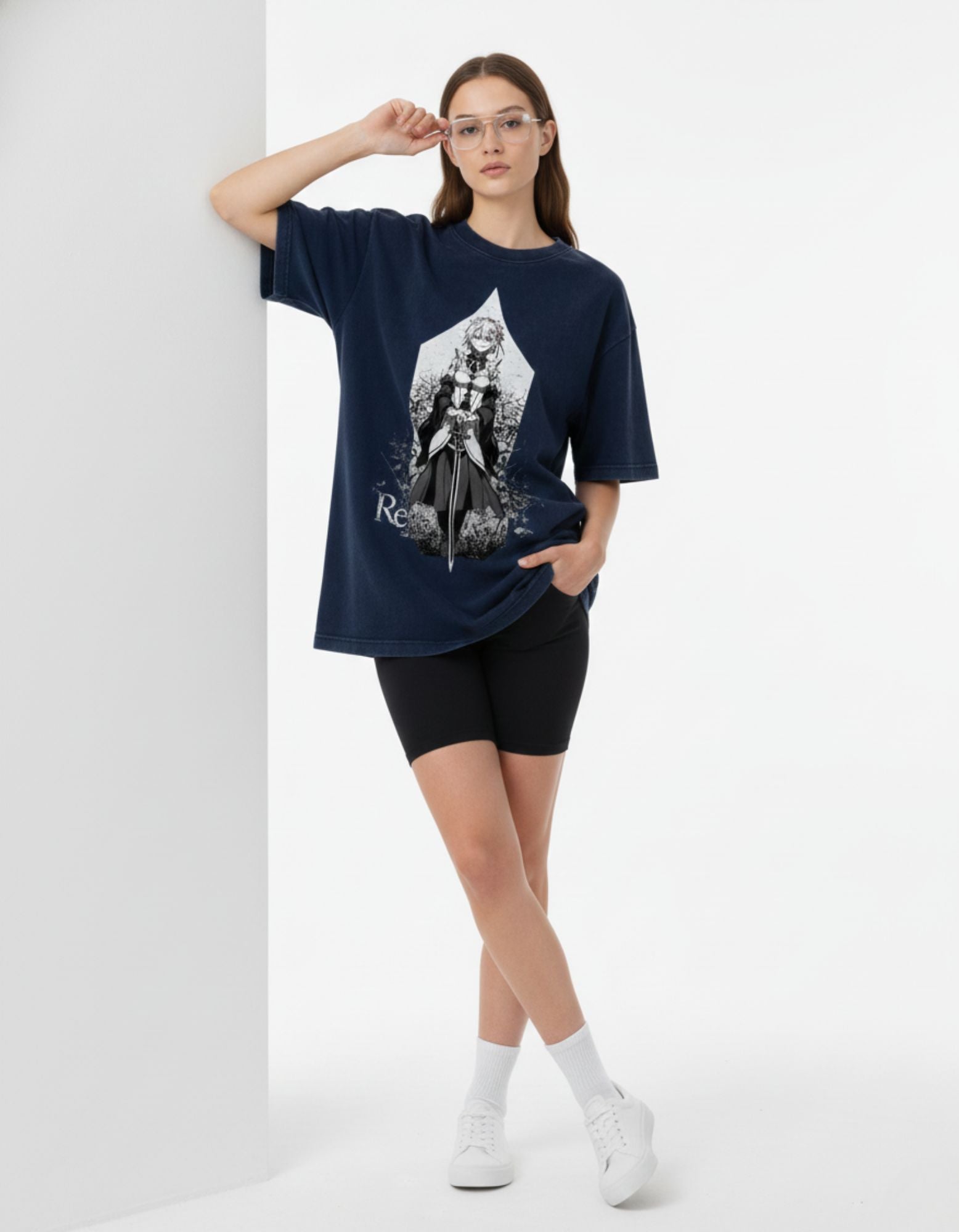 Indian woman leaning against a wall wearing a navy blue anime-themed baggy t-shirt, perfect for "Anime India" fan culture.