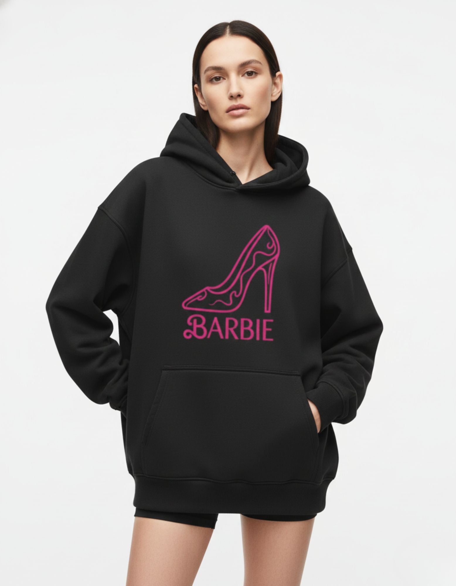Fashionable oversized black hoodie with pink Barbie design, styled as a streetwear outfit for women.