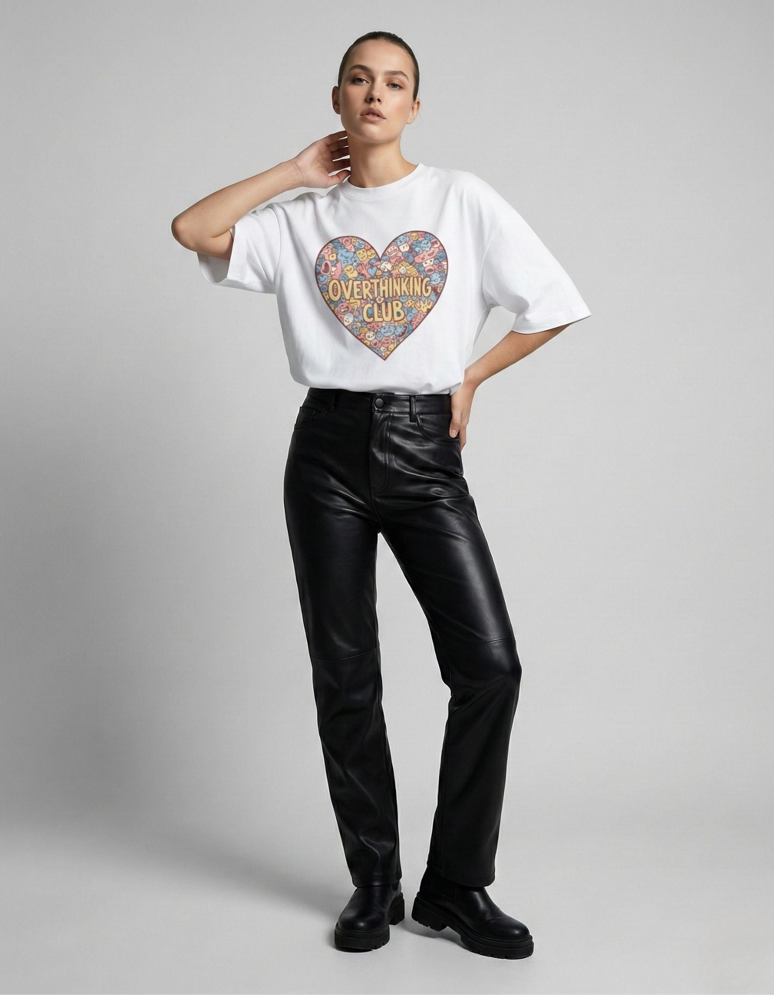 Indian female model in a baggy white graphic tee and leather trousers, showcasing a premium streetwear look for 2025.