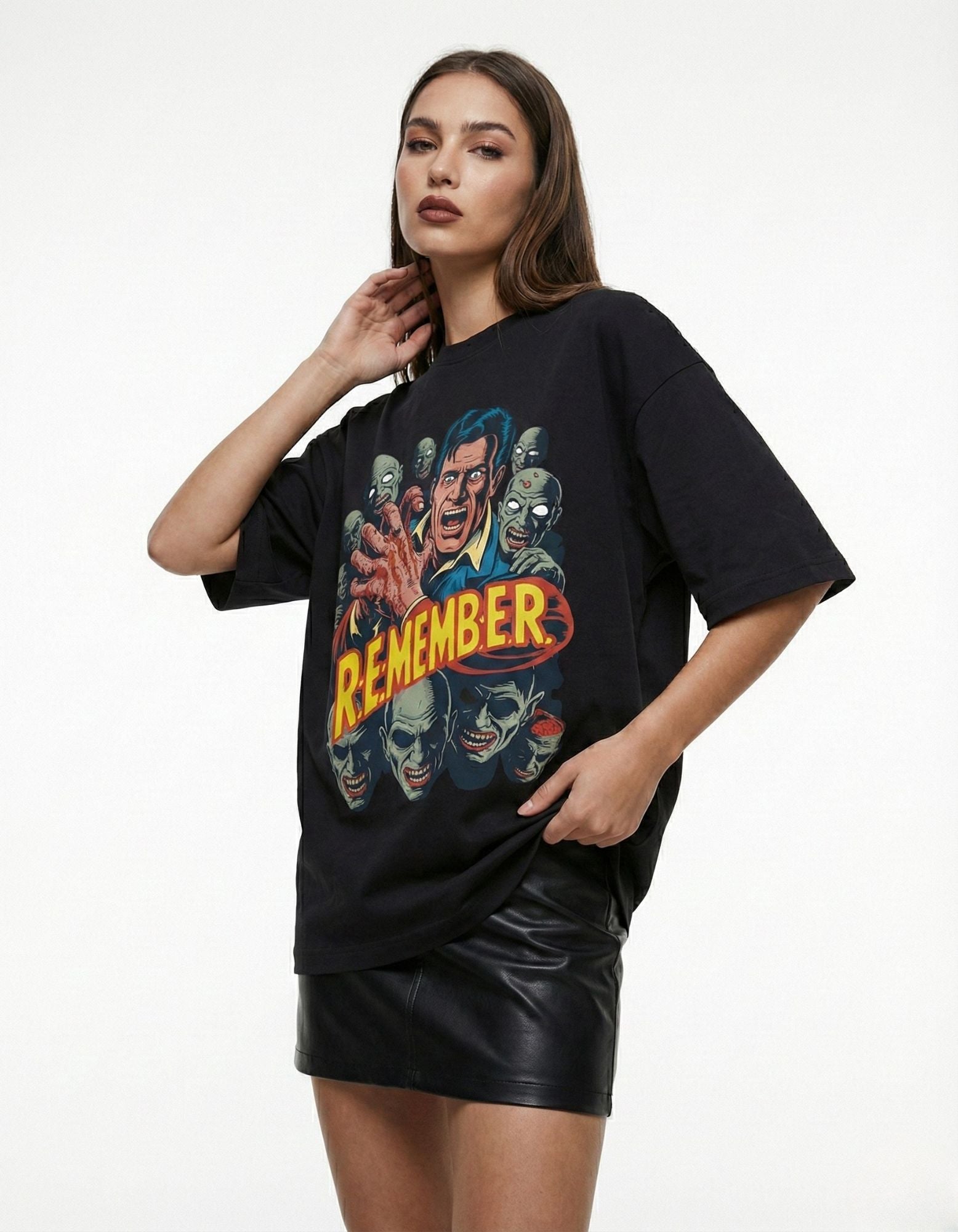 High-angle shot of a woman in a black "R.E.M.E.M.B.E.R" horror graphic tee, highlighting the high-quality print detail and premium cotton fabric.