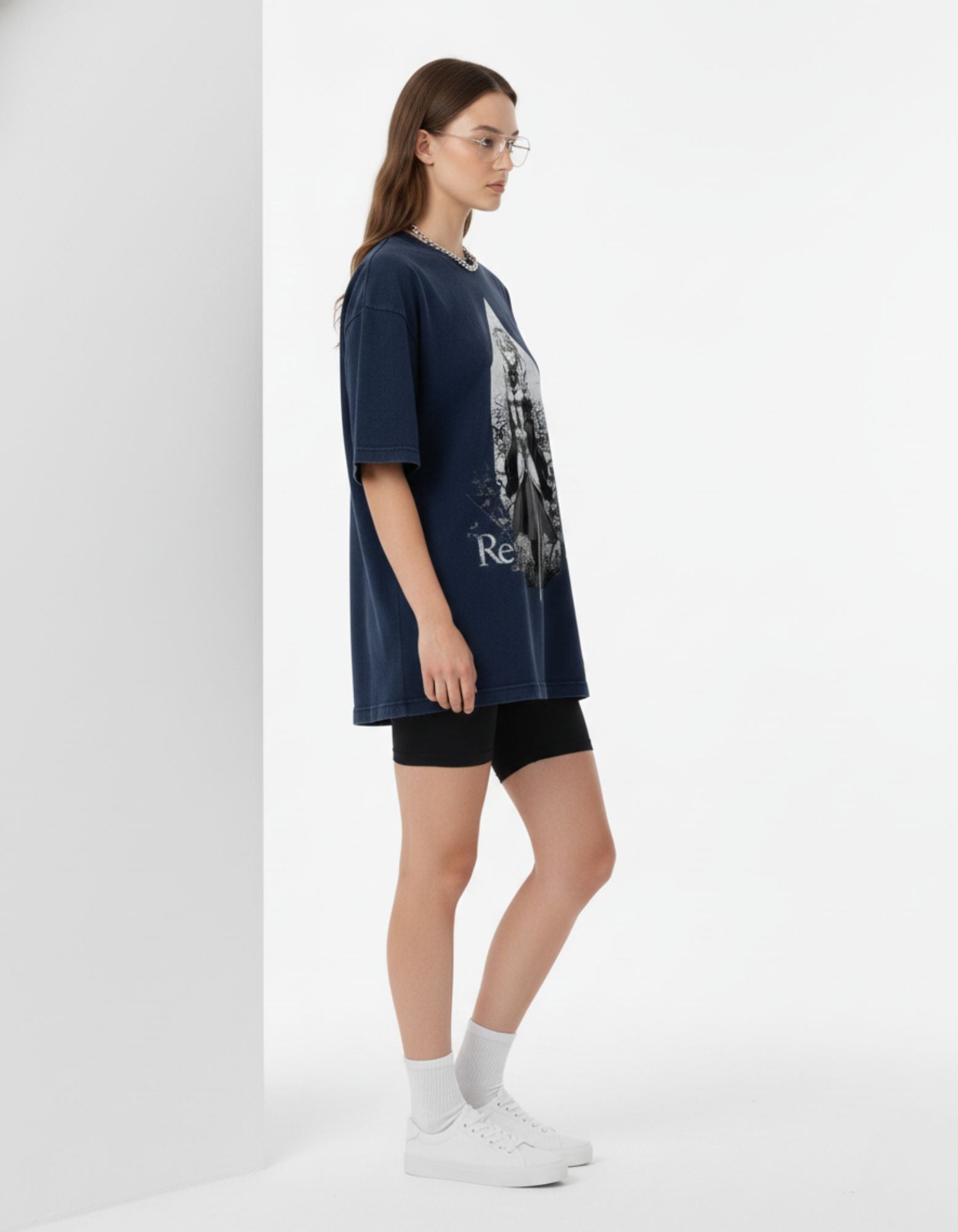 Side profile of a woman in a navy blue GENZs Fashion oversized tee, highlighting the drop-shoulder and heavy cotton drape.