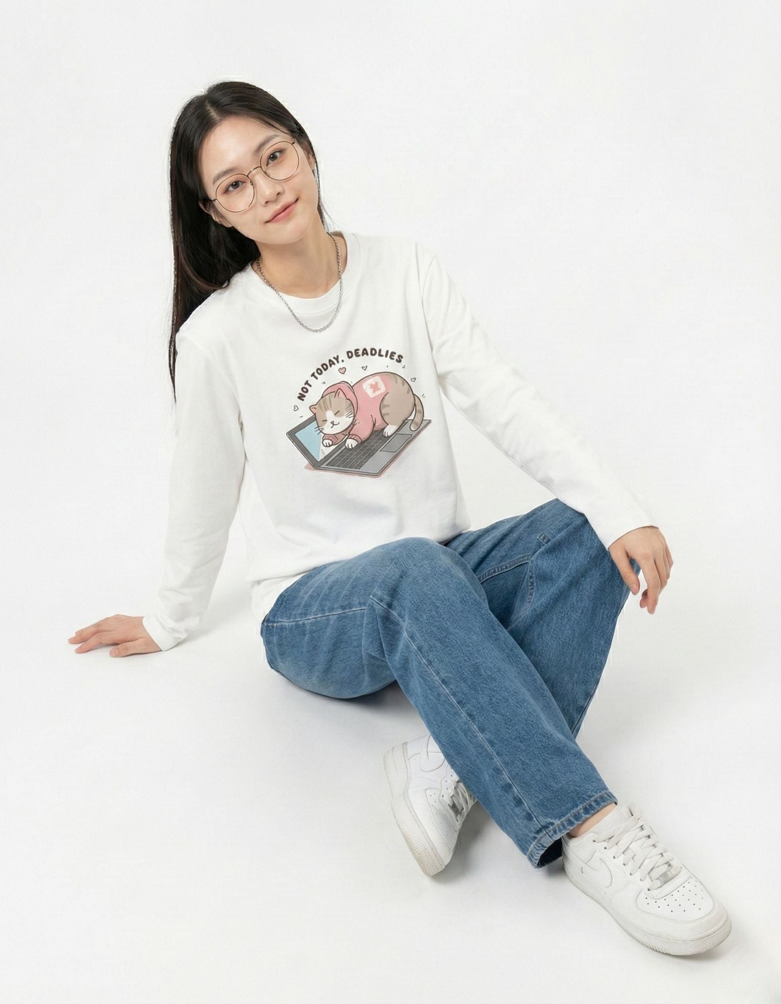 Female model sitting in a GENZs Fashion white "Not Today" graphic top and blue jeans, representing relaxed Gen Z lounge-wear trends.