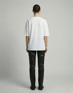 Rear view of a white oversized t-shirt for women, demonstrating the premium street-style silhouette and clean back finish.