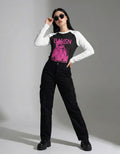 Full-body streetwear outfit featuring a BAYGN pink graphic raglan long-sleeve shirt and black cargo pants.