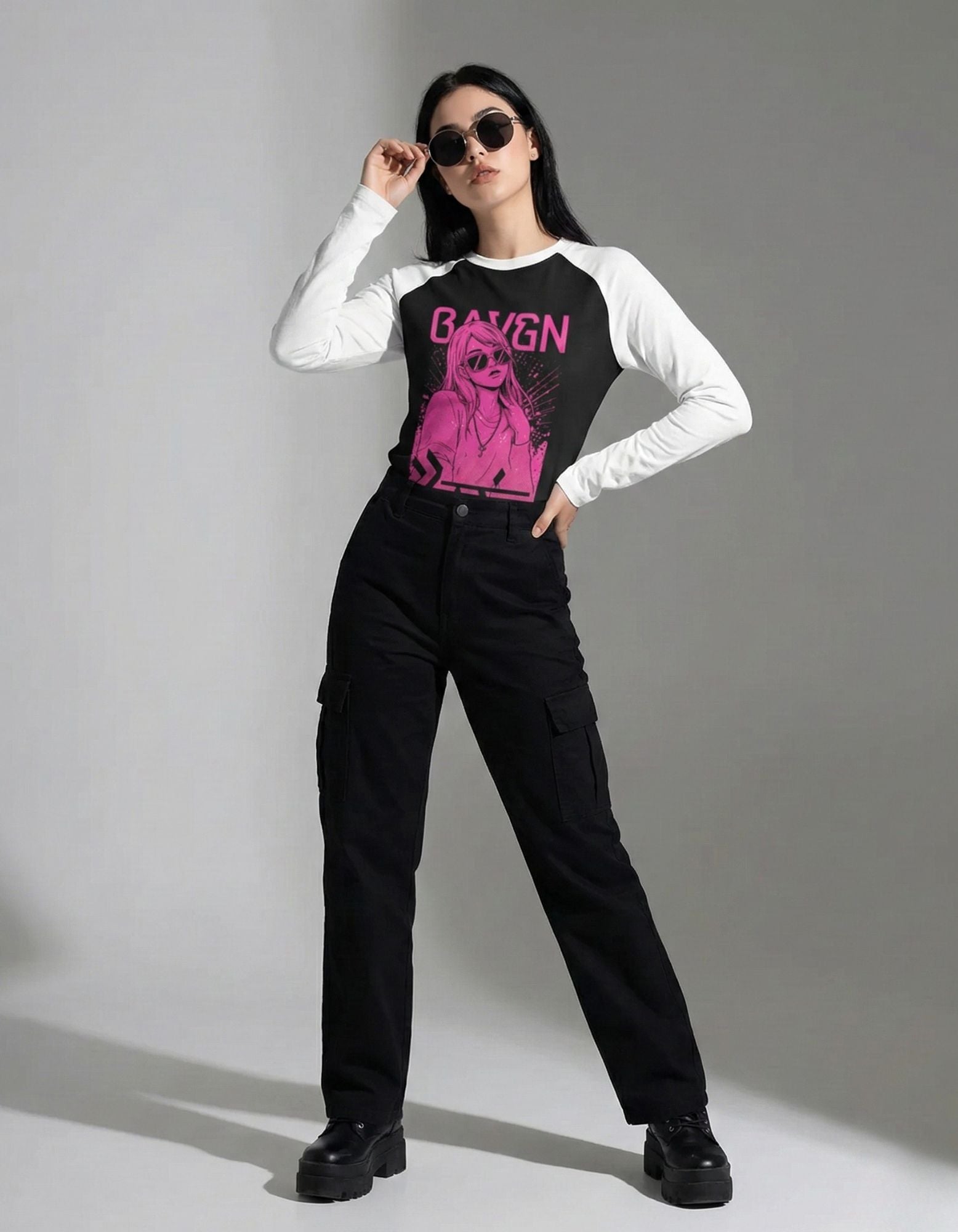 Full-body streetwear outfit featuring a BAYGN pink graphic raglan long-sleeve shirt and black cargo pants.