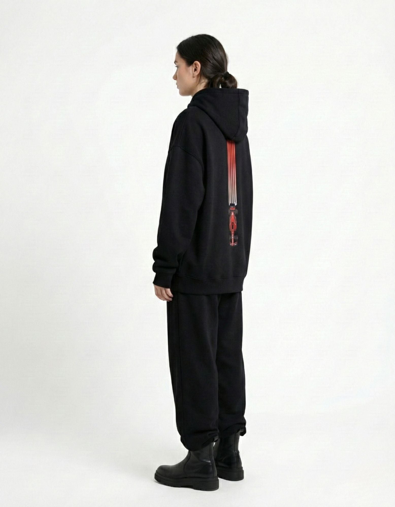 Side view of female model wearing a premium black F1 racing streetwear hoodie by GENZs Fashion, oversized fit.