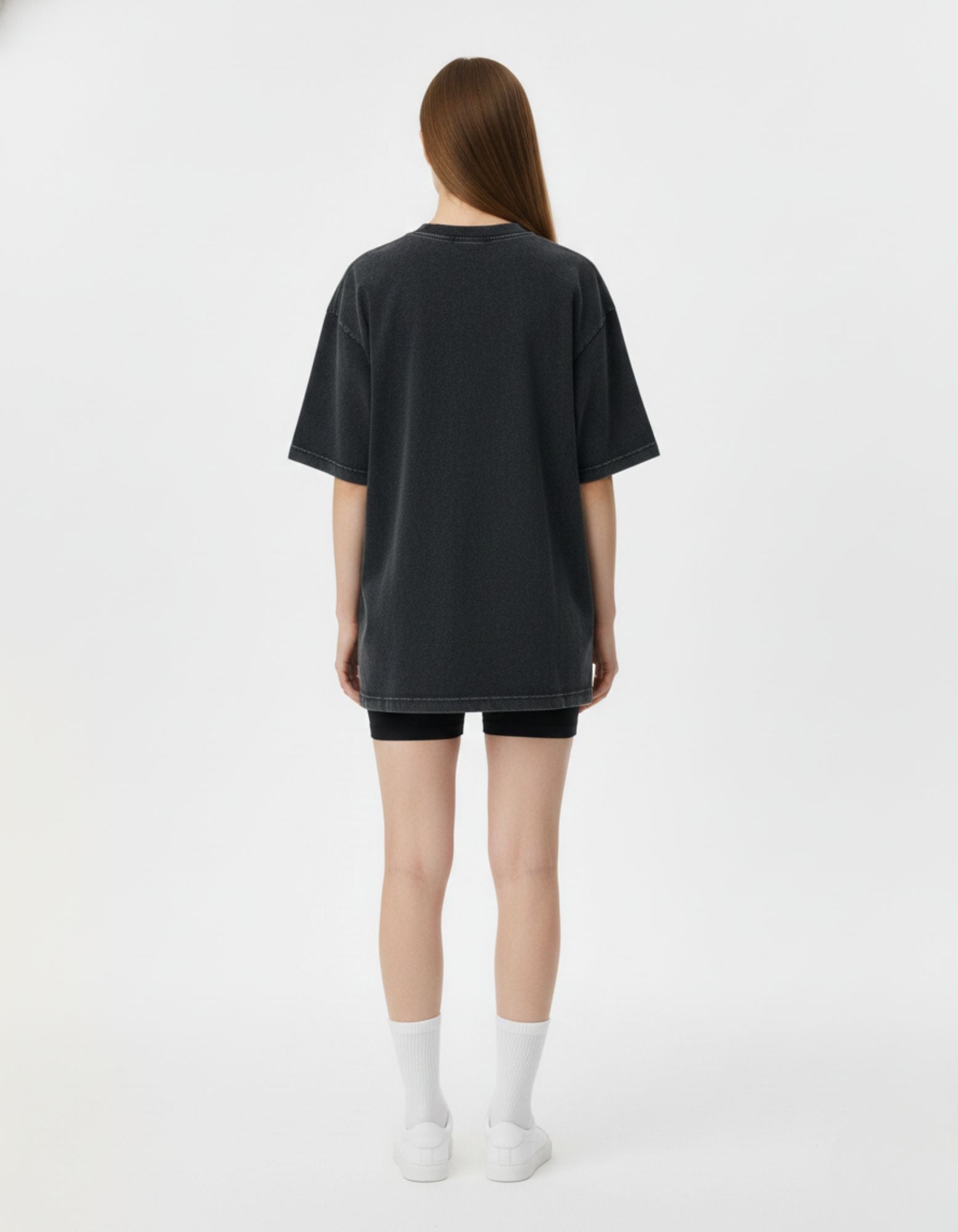 Rear view of a woman wearing the GENZs Fashion oversized vintage black streetwear t-shirt, highlighting the dropped shoulder design.