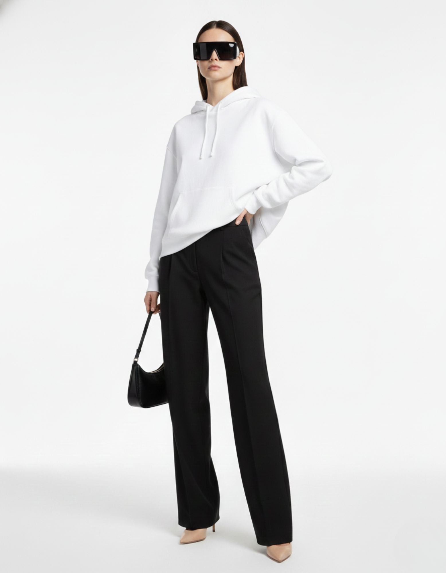 "Front view of a high-quality white women's hoodie with a front pouch pocket, styled for a luxury streetwear aesthetic."