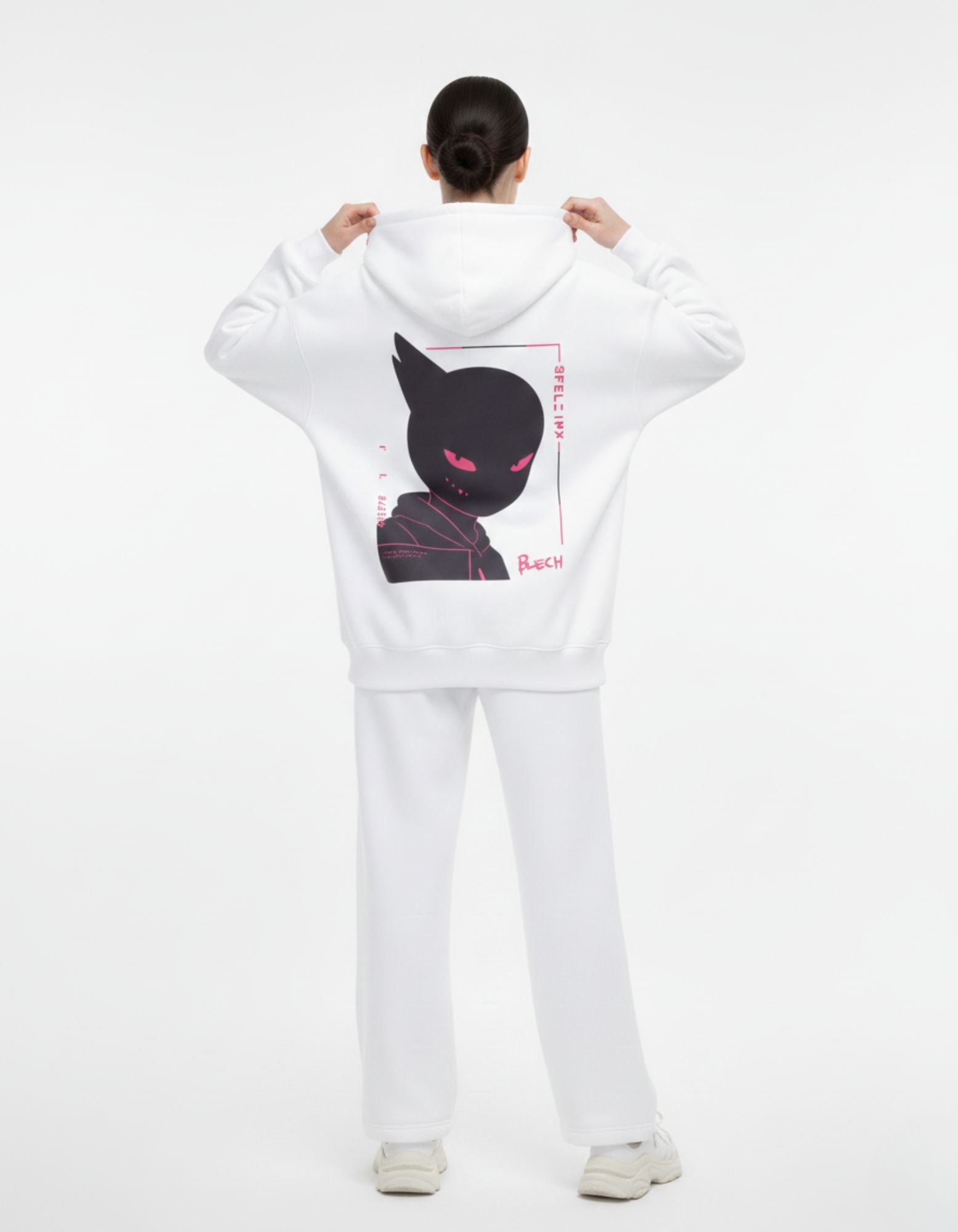 Back view of female model wearing the white GENZs Fashion "Pink Eye" anime graphic hoodie, oversized fit for a Y2K look.