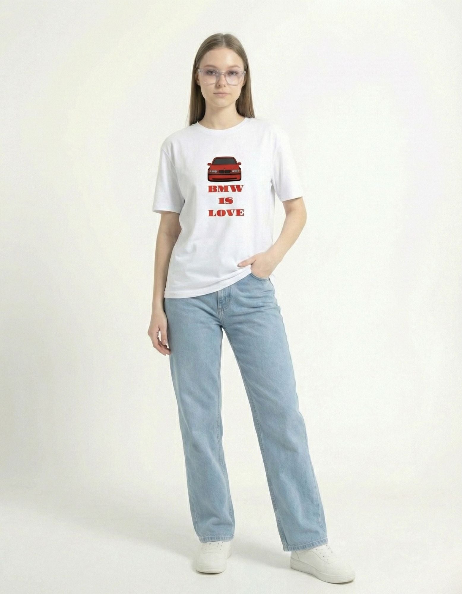 Female model in a white oversized car enthusiast t-shirt featuring a red BMW graphic and 'BMW IS LOVE' slogan.