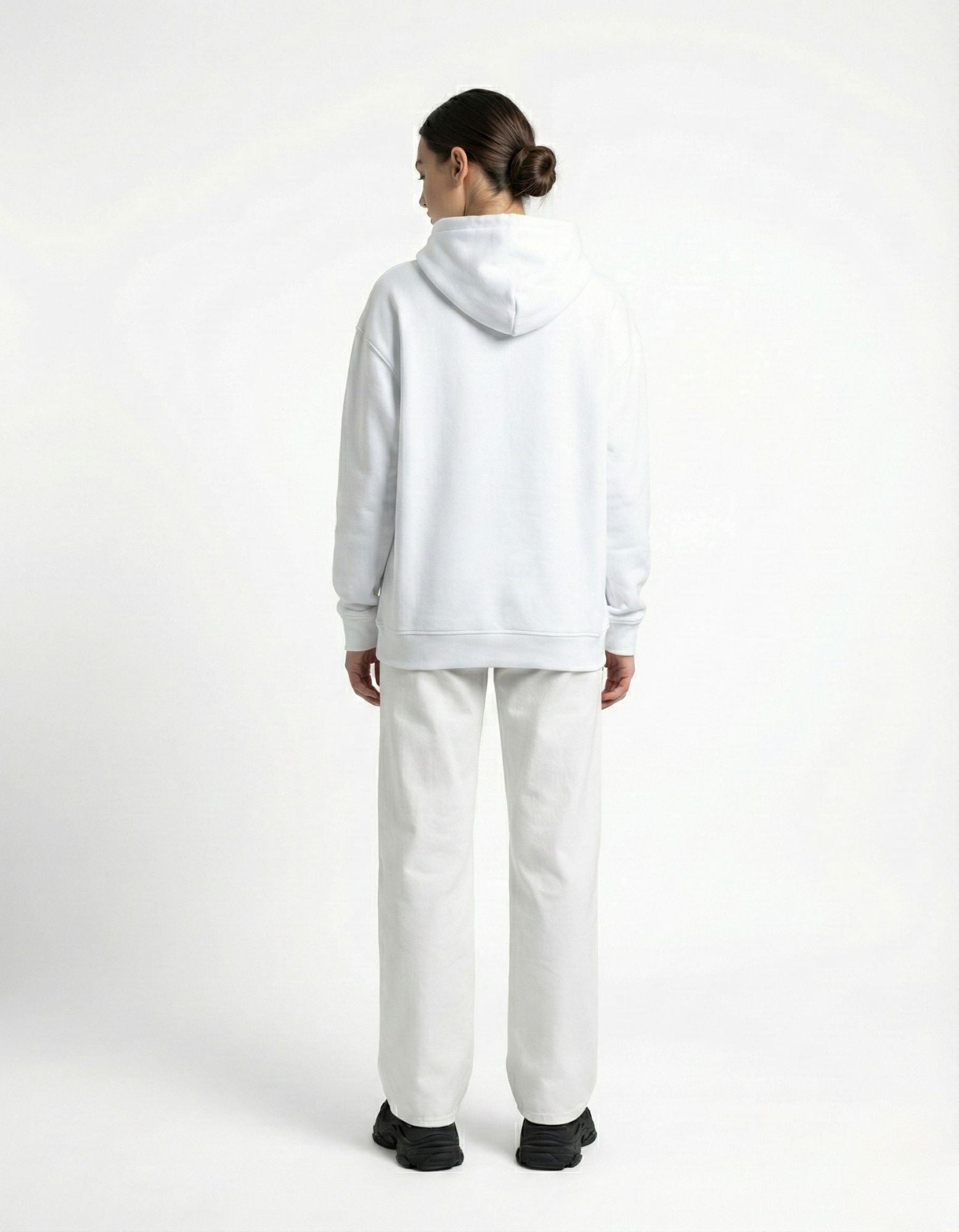 Back view of a female model wearing a GENZs FASHION white hoodie with white wide-leg jeans.