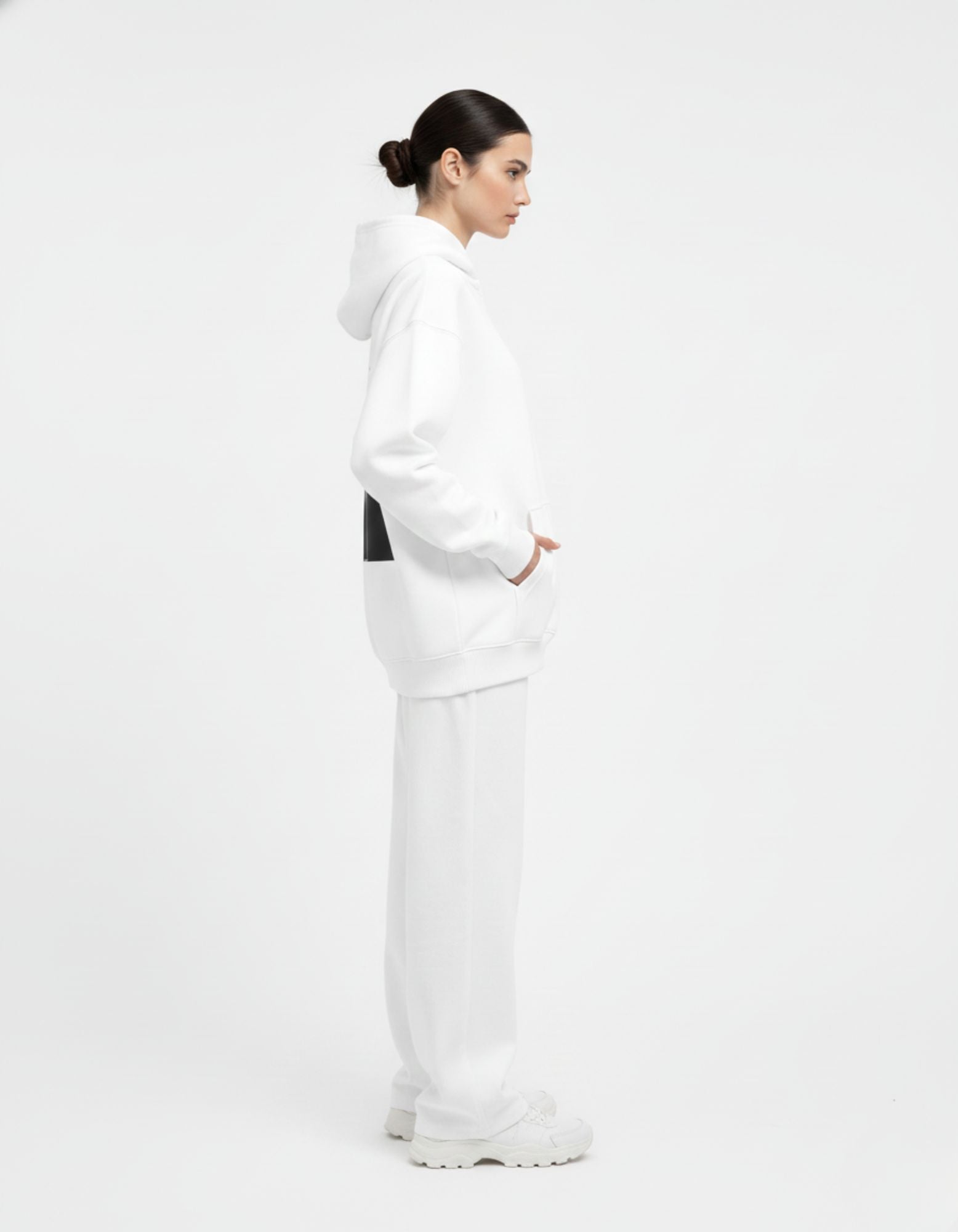 Side profile of female model wearing GENZs Fashion white oversized hoodie, perfect for Gen Z streetwear outfits.