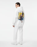 Detailed back view of a male model wearing a GENZs Fashion white hoodie with a colorful Jujutsu Kaisen character trio graphic print.